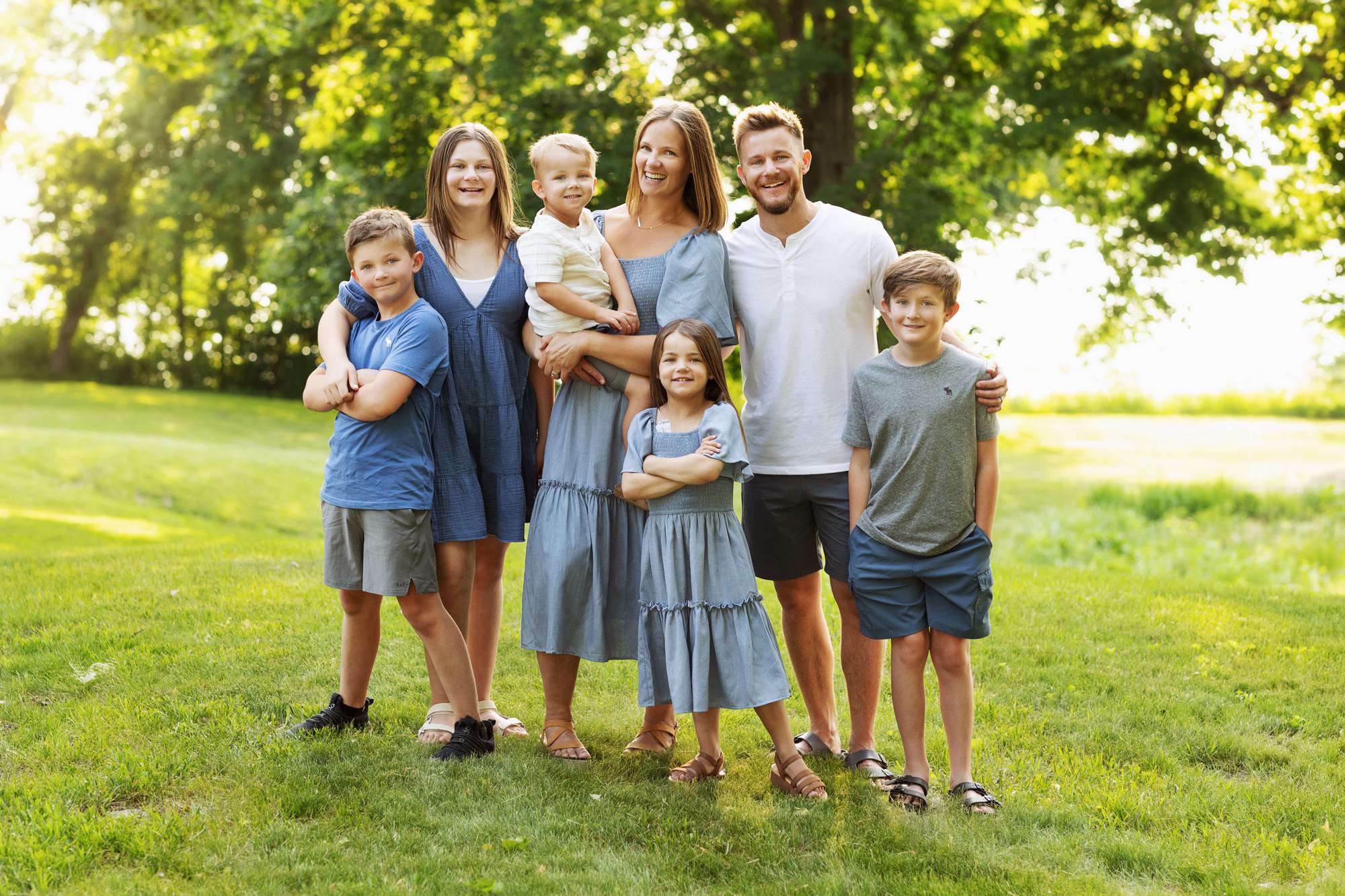 Relaxed family photo session in downtown Buffalo MN with greenery backdrop