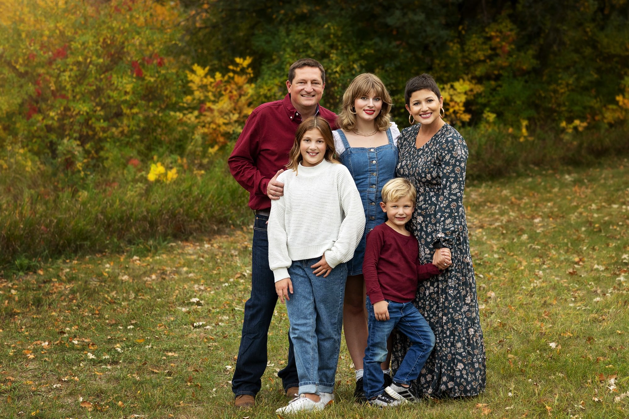 a family with perfect outfits for fall family pics in MN