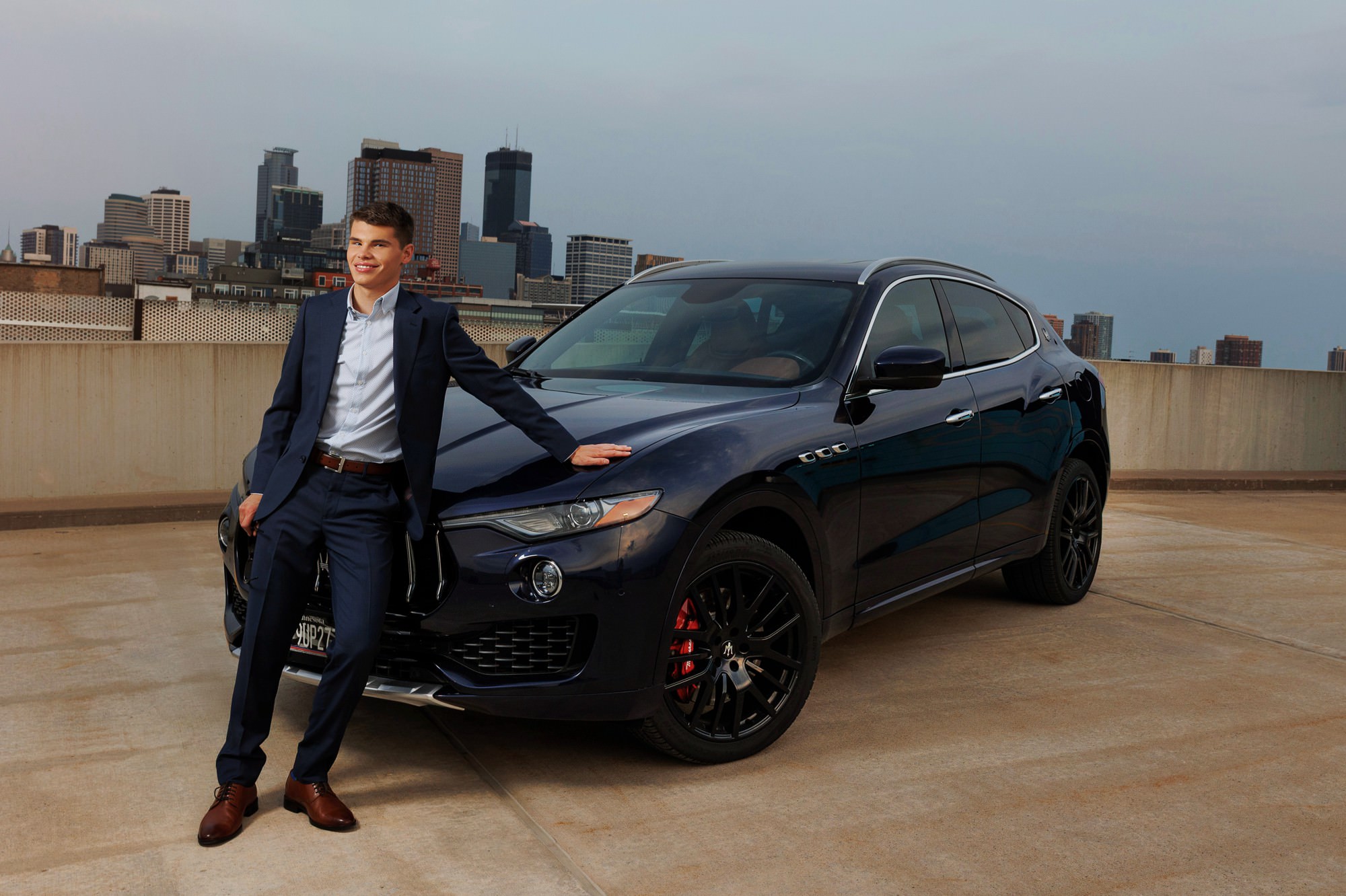 Minneapolis skyline senior portrait with a Maserati on a parking ramp