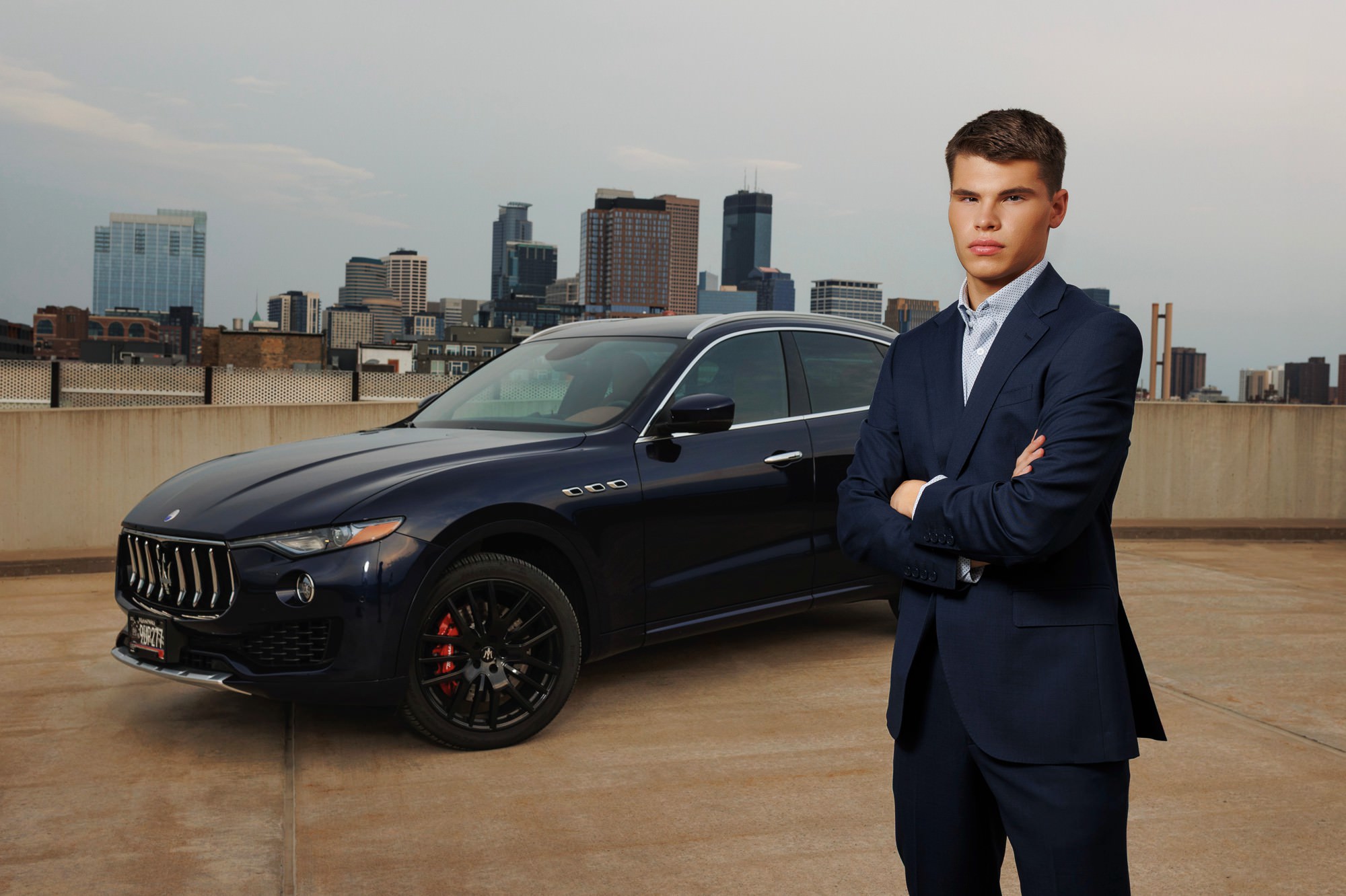 Minneapolis skyline senior picture of guy with car