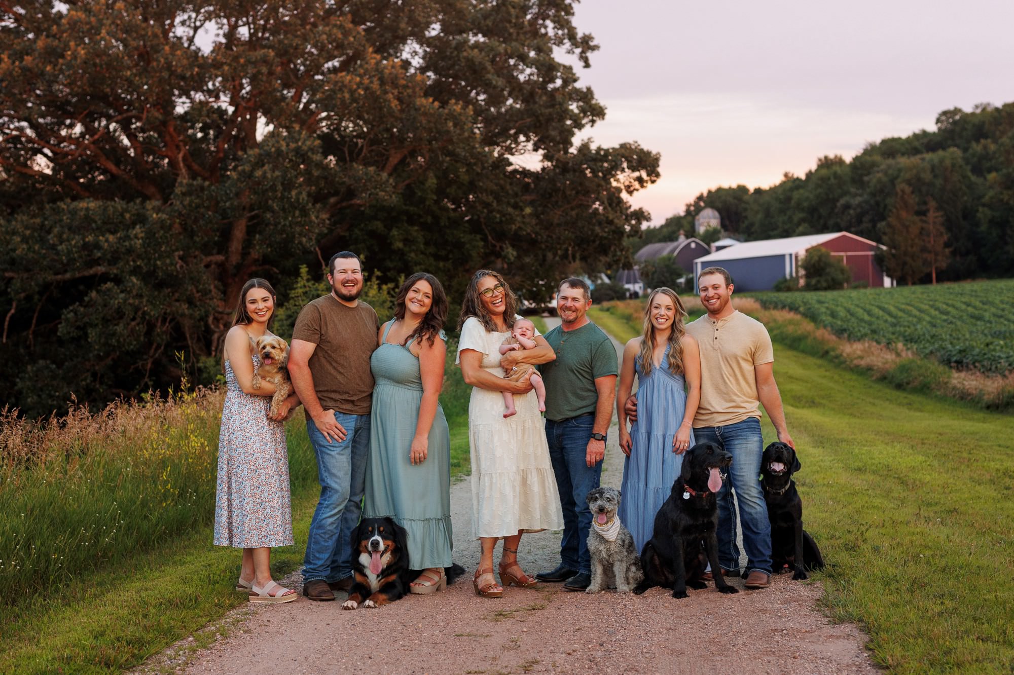 Family portrait featuring beloved pets during an outdoor Minnesota family session.