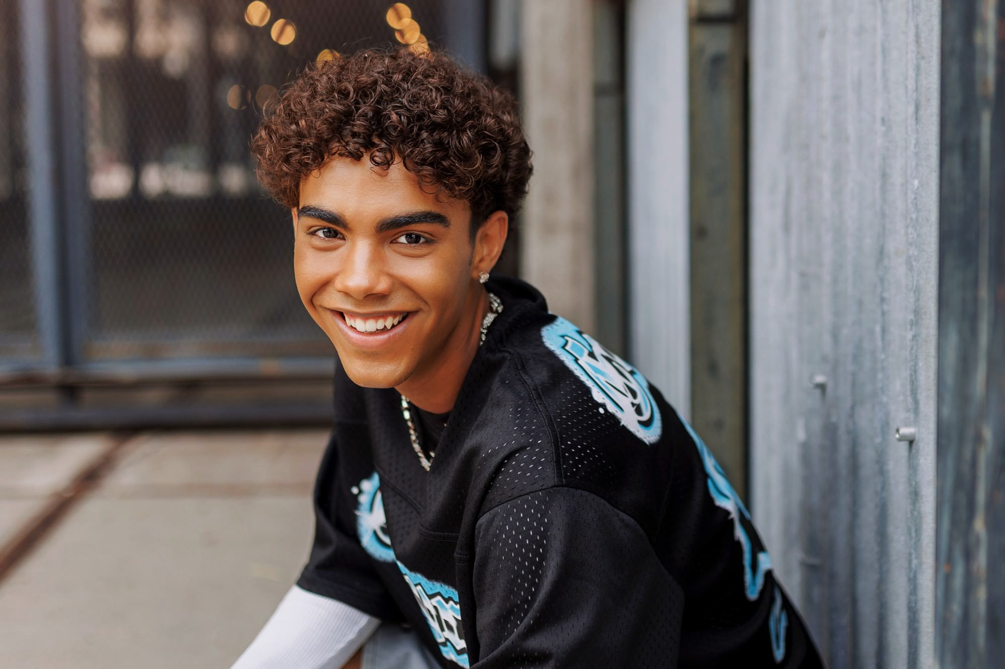Senior guy laughing during urban Minneapolis senior photo session