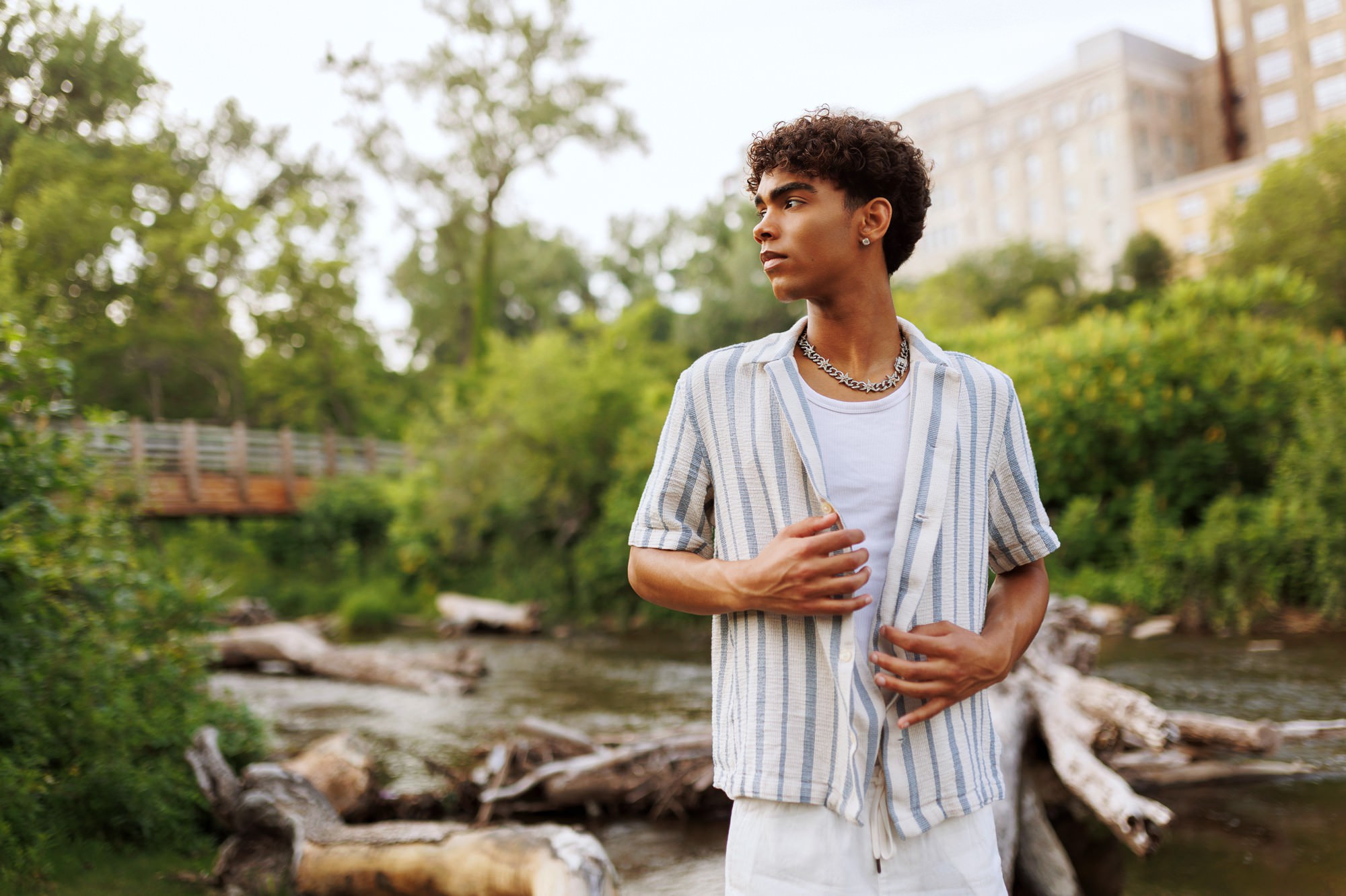 Stylish photos of high school senior boy surrounded by nature near Mississippi River in Minneapolis